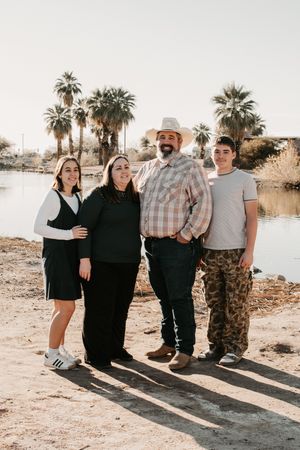 Family embracing together during sunset portraits in Phoenix Arizona.