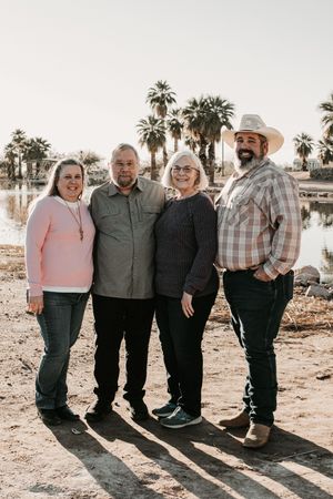 Family walking together beneath desert mountains in Buckeye Arizona.