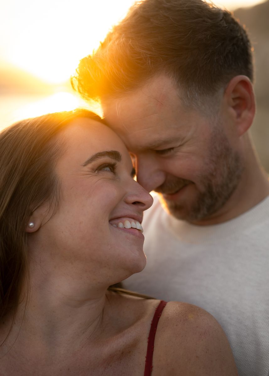 Close-up of romantic couple sharing intimate moment at sunset.