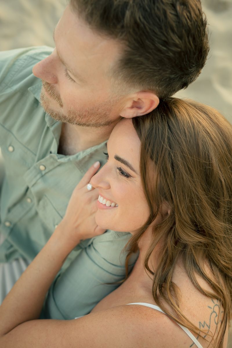 Close up portrait of couple in soft natural lighting at beach.