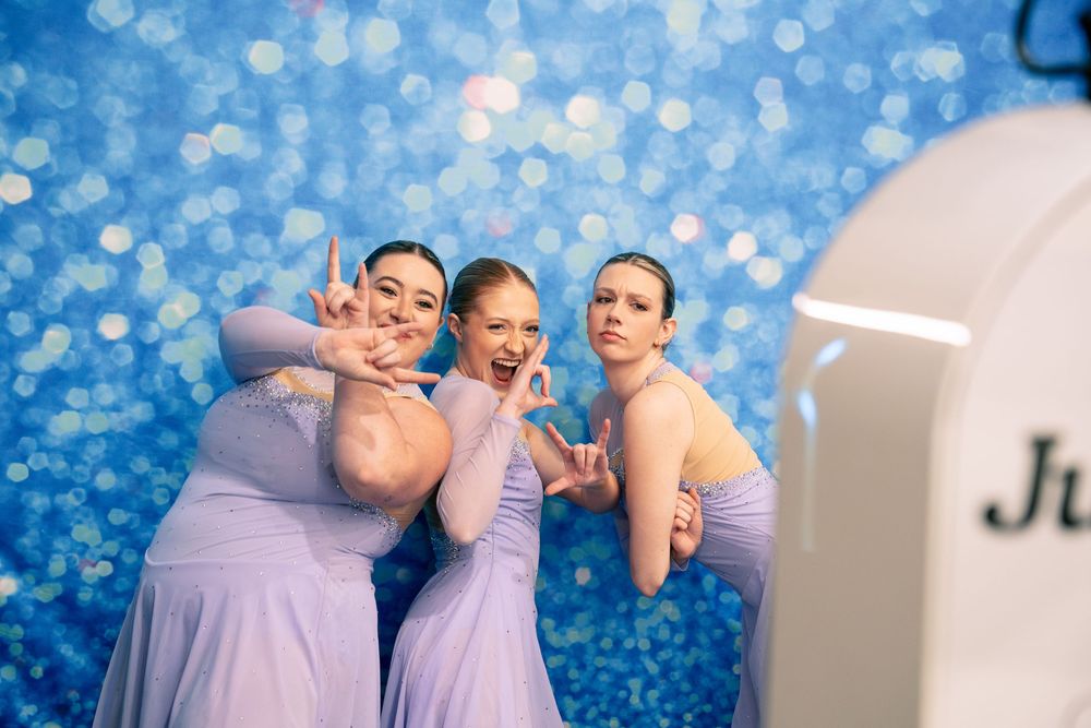 Three women have their photo taken by the Just Say Cheese photo booth