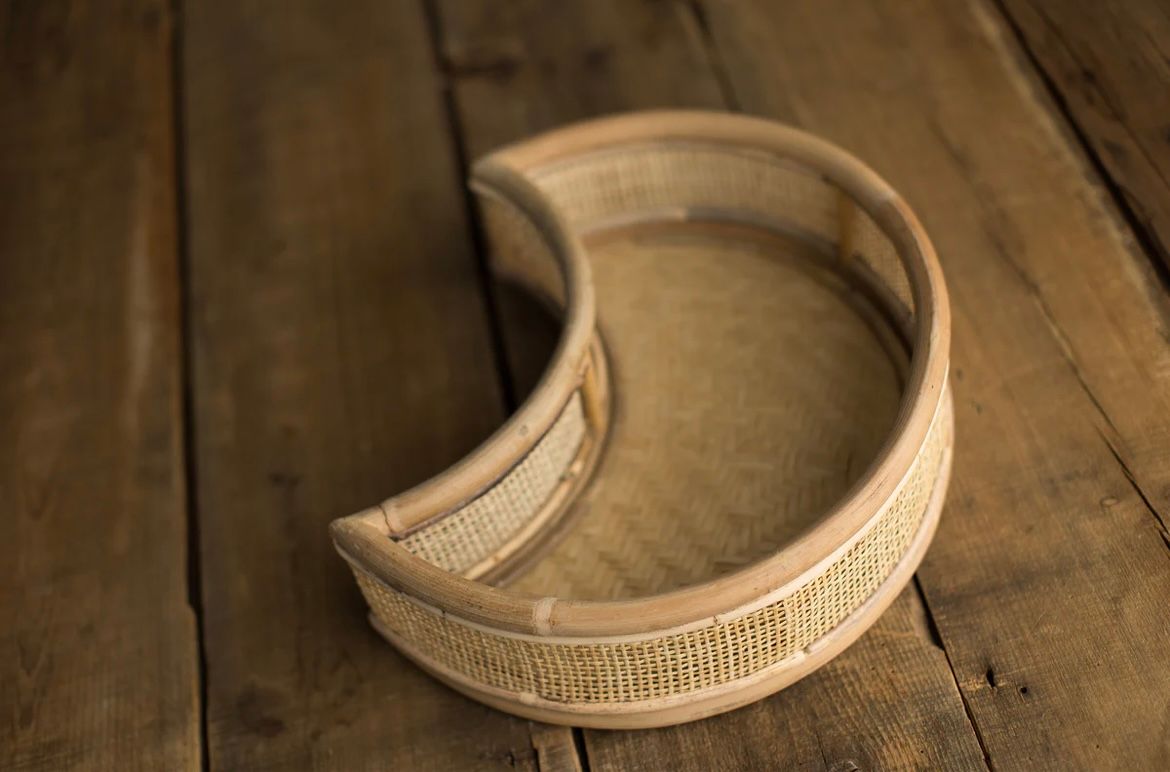 Two wood embroidery hoops used for crafting and needlework shown on a rustic wooden surface.