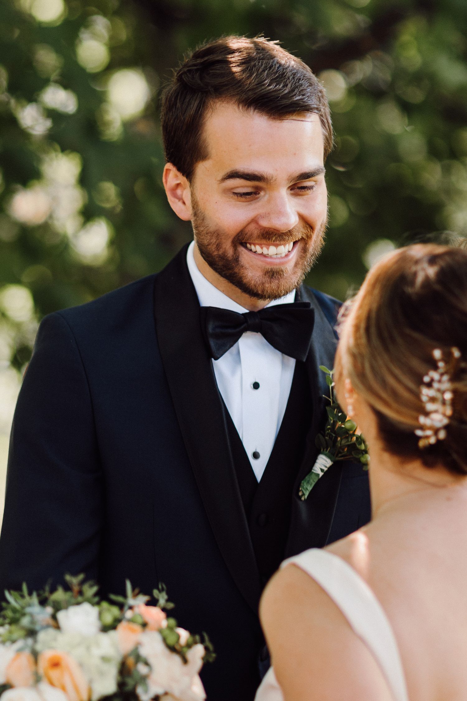 A tender moment between newlyweds during their outdoor wedding ceremony.