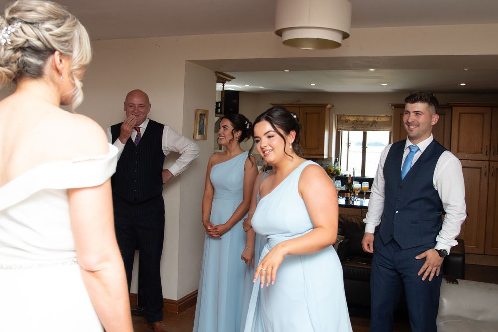 Wedding party getting ready indoors with natural lighting.
