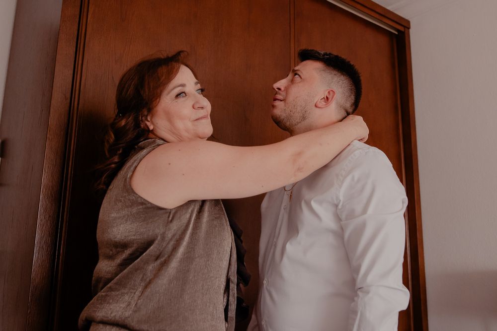 Candid moments captured during wedding preparations in a warmly lit room.