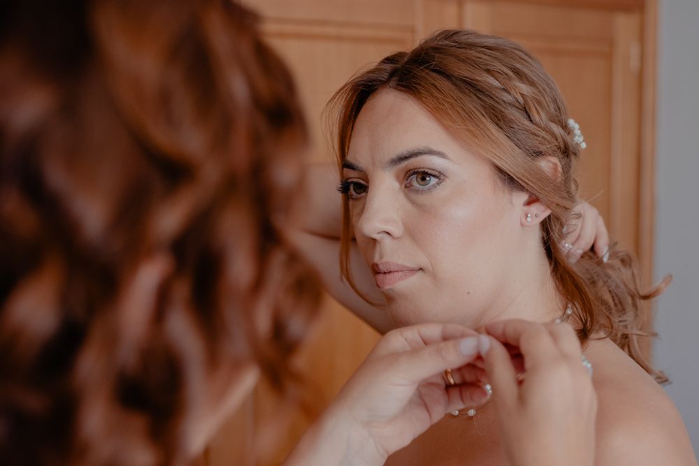 Soft natural makeup and romantic hairstyle captured in warm lighting.