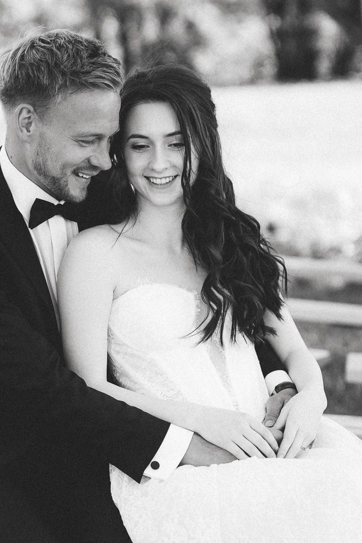 Close up black and white portrait of a bride and groom sharing an intimate moment together.