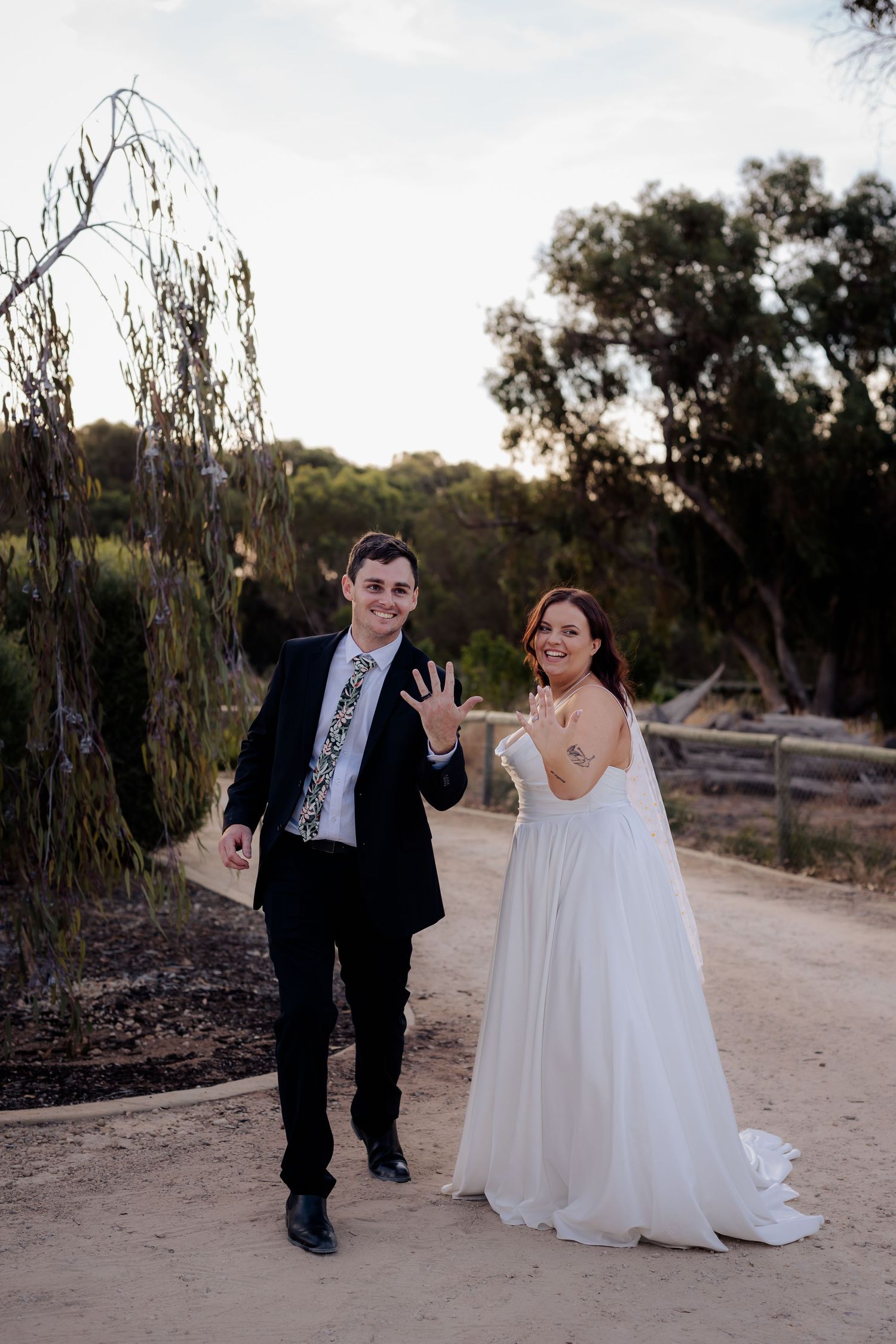 Wedding party enjoying outdoor garden photoshoot at sunset with elegant poses and natural lighting.