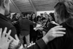 A group of people gathered in a circle during a celebratory moment.