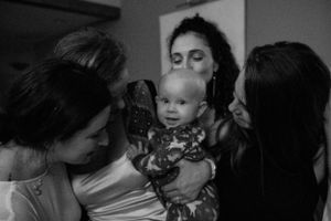 A small gathering of people huddle together in an intimate black and white moment.