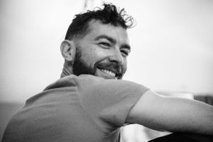 A black and white portrait captures a relaxed candid moment.
