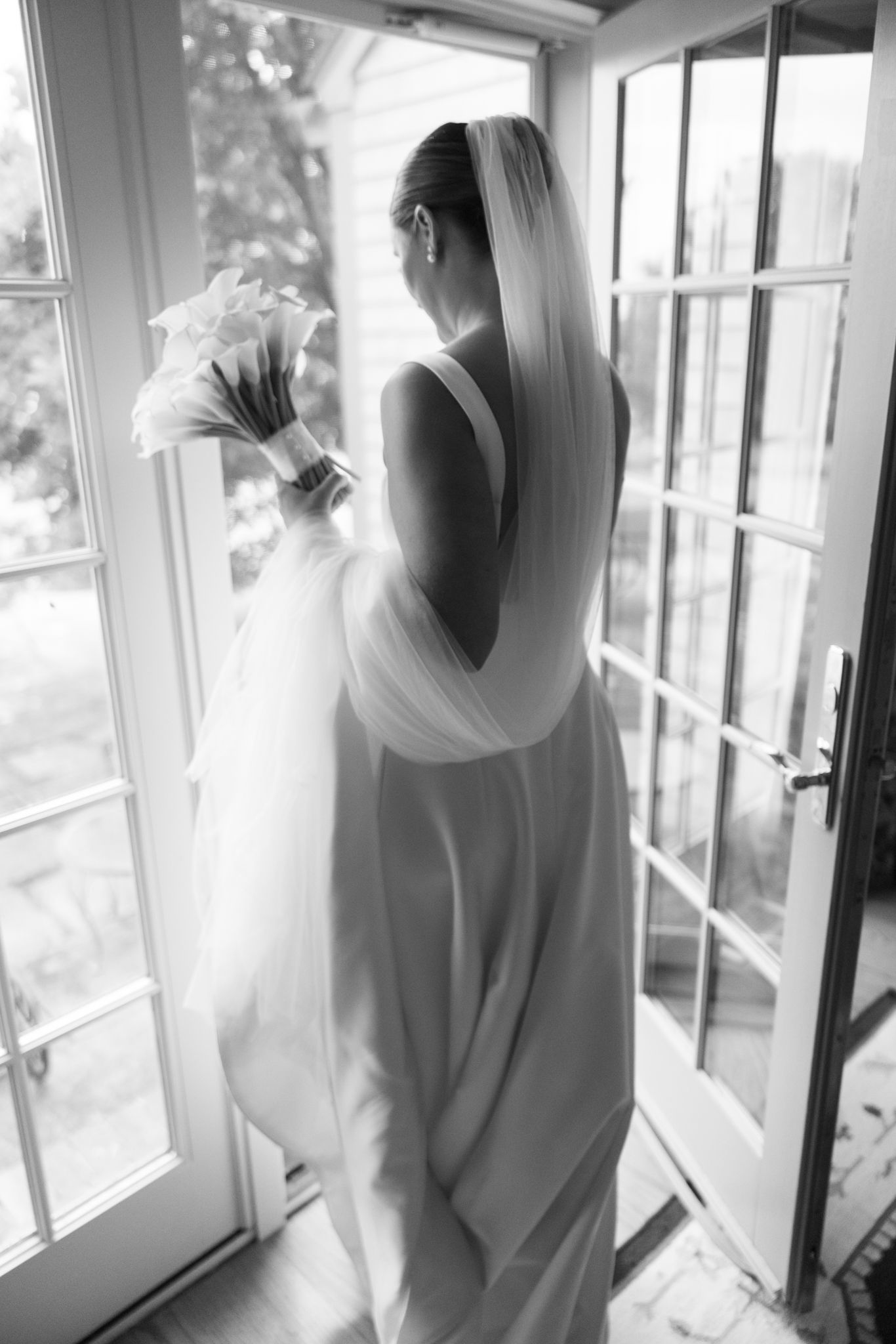 Artistic black and white photos of bridal preparations near sunlit windows.