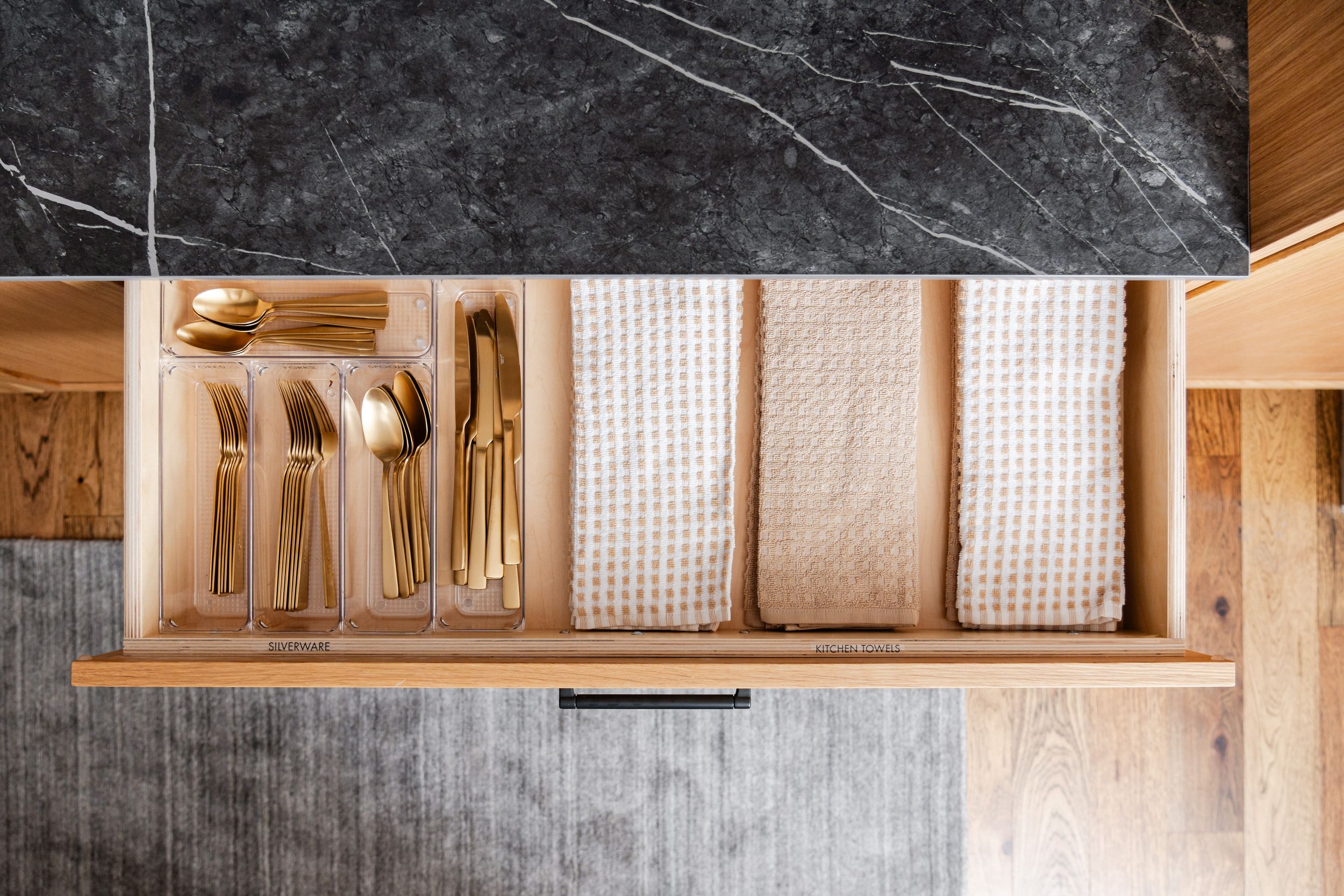 Wooden wall storage solution with open shelves displaying organized files and documents in a modern office space.