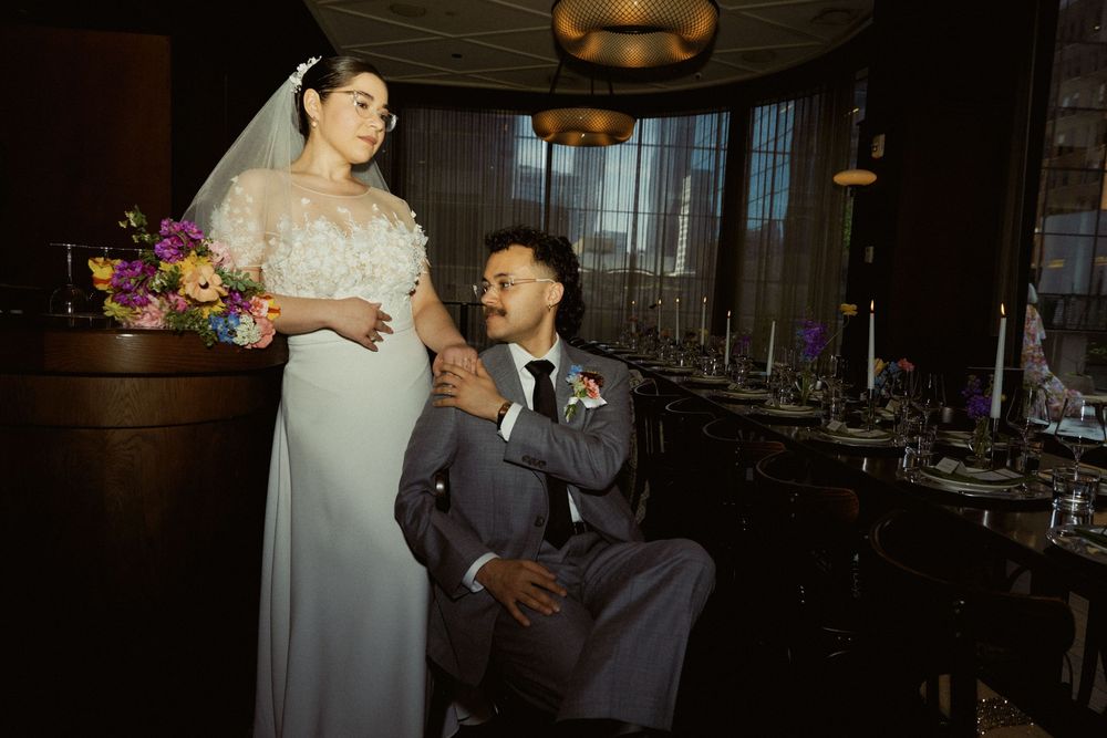 Romantic wedding portrait with moody lighting in an elegant restaurant setting.