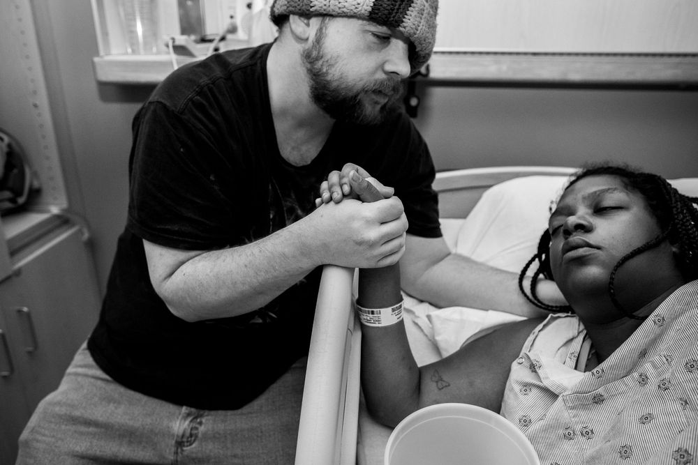 Healthcare workers providing medical attention to a patient in a clinical setting.