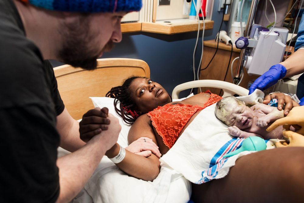 Healthcare providers working together in a medical setting with monitoring equipment.