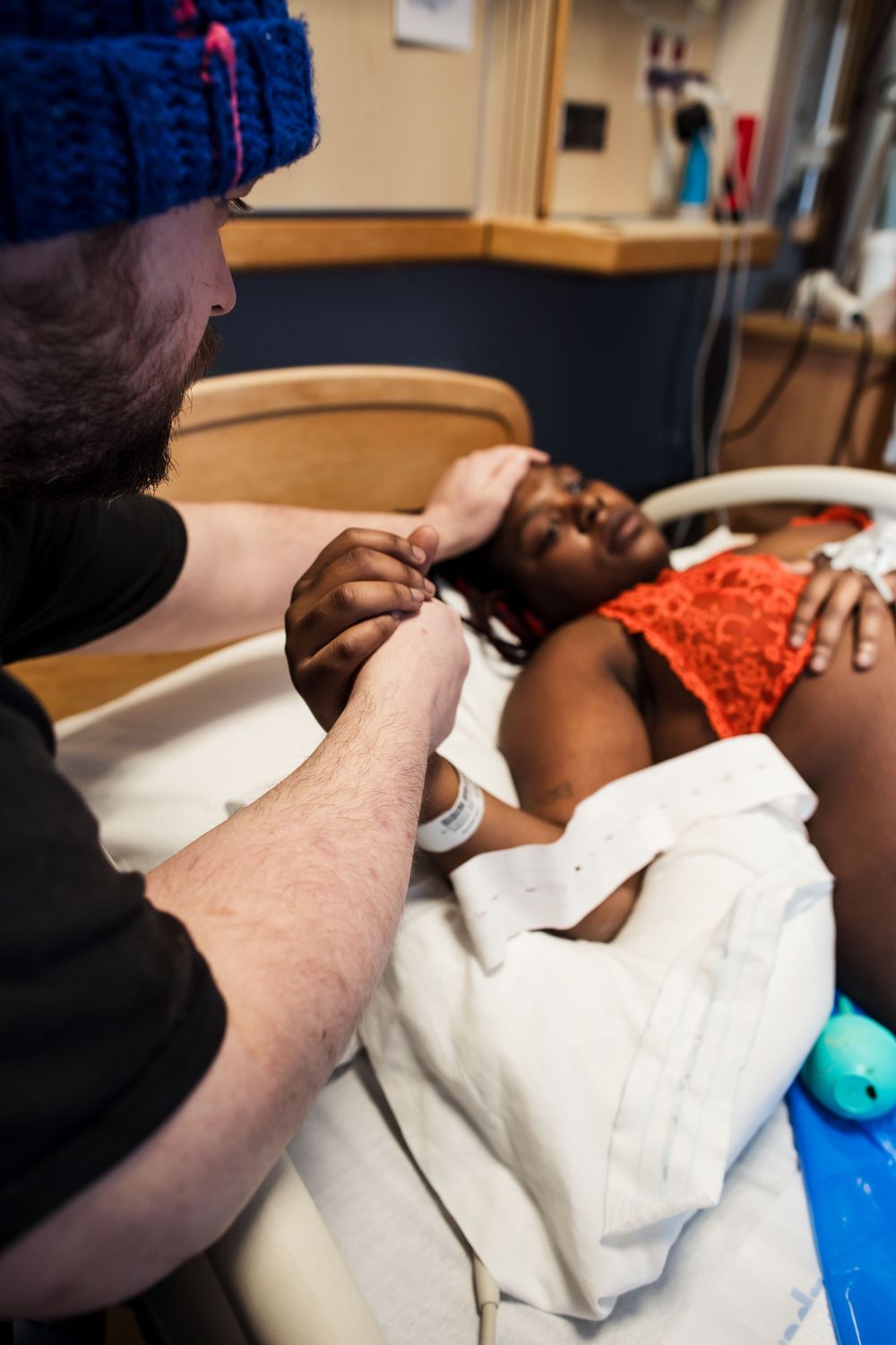 Medical professionals providing care to a patient on a hospital bed.