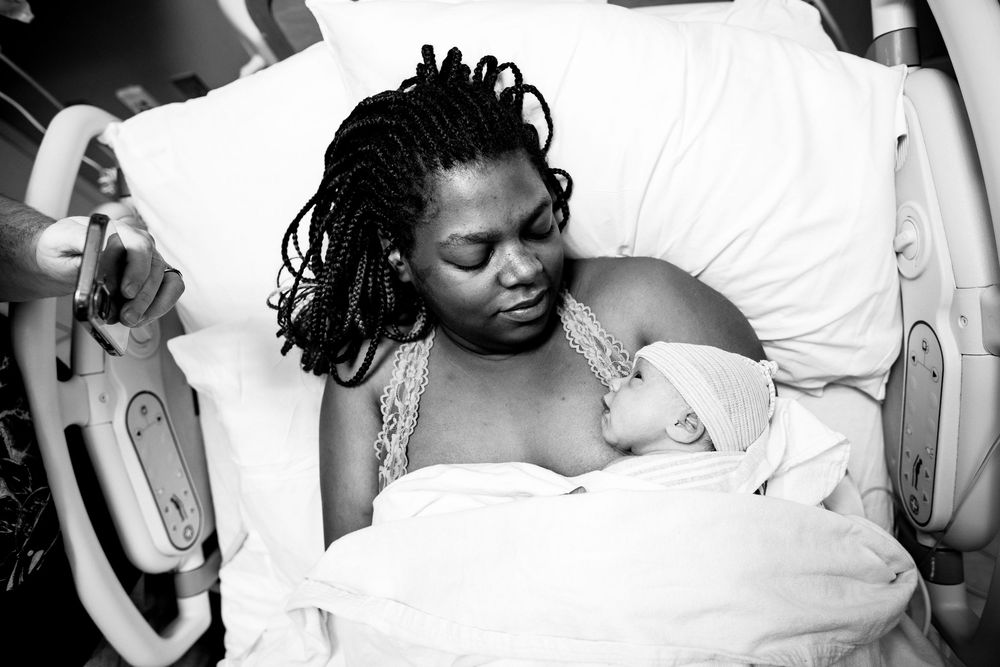 Black and white image of a patient receiving care in a medical setting.