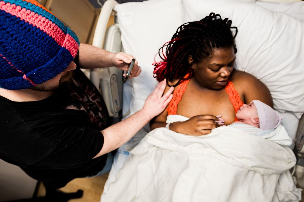 Healthcare providers attending to patient in hospital room.