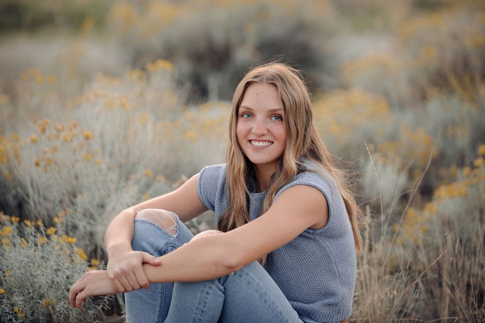 A casual portrait session in a field of sage brush during golden hour.