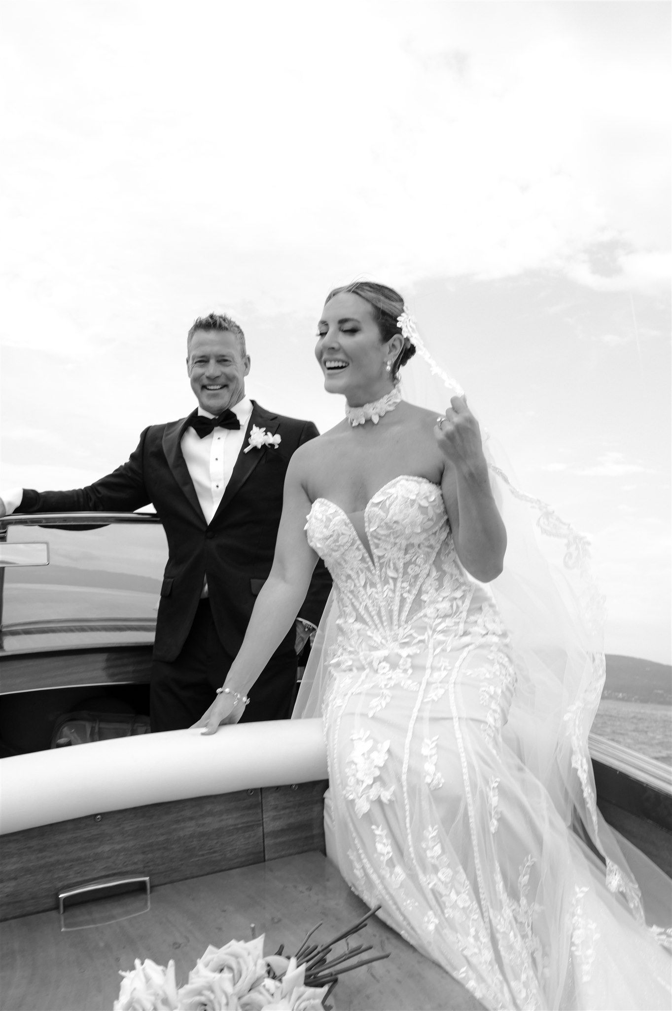 Romantic black and white wedding portraits on a yacht deck.