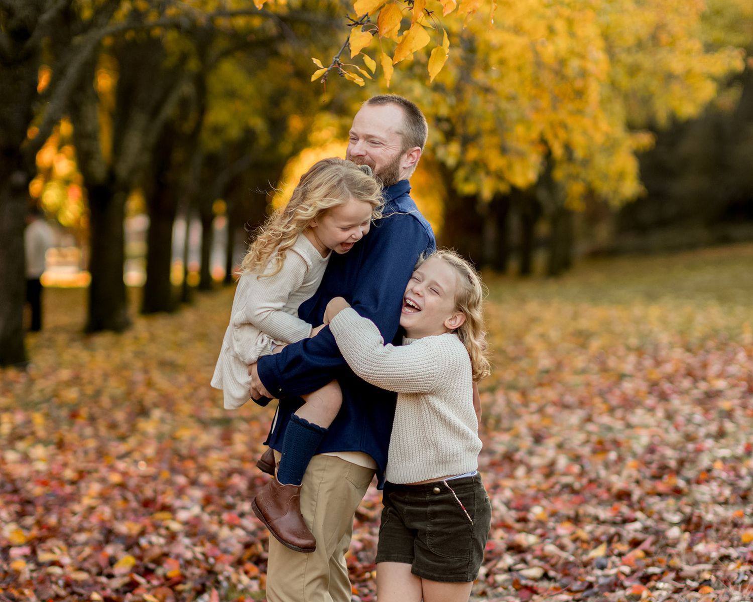 Series of portrait photos showing child with curly blonde hair laughing and playing in autumn leaves background.