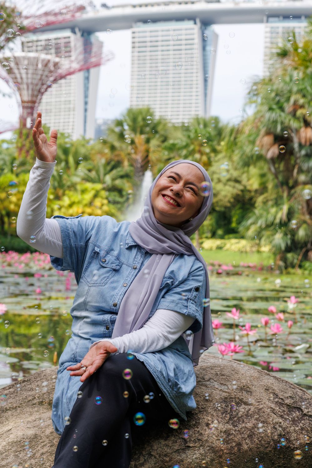 Joyful moment captured at Gardens by the Bay with Marina Bay Sands hotel in background.