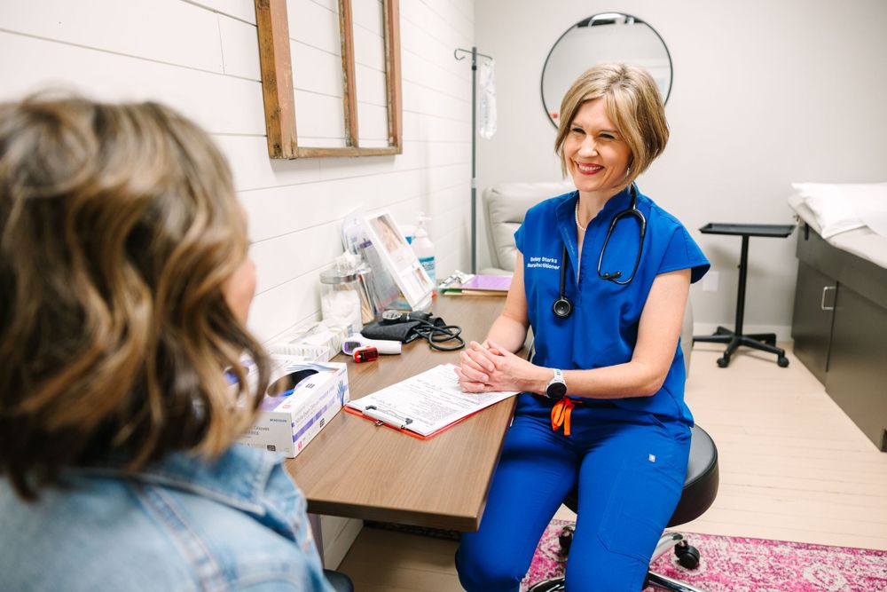 Healthcare consultation taking place in a medical examination room.