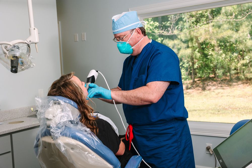 Dental procedure being performed in a modern treatment room with large window.