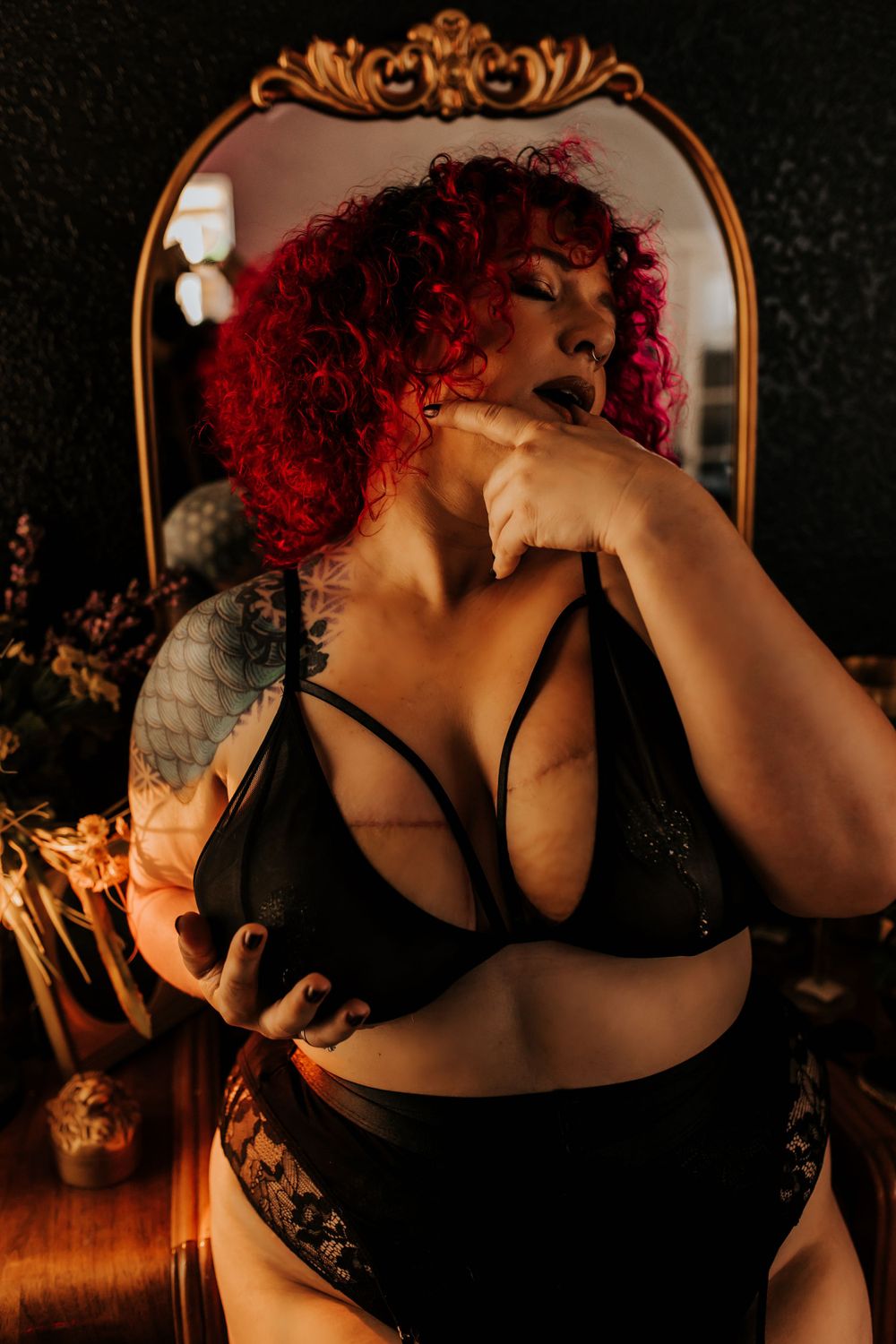 Luxury moody boudoir session featuring dark leather outfit and bold confident posing at Unbound Studios