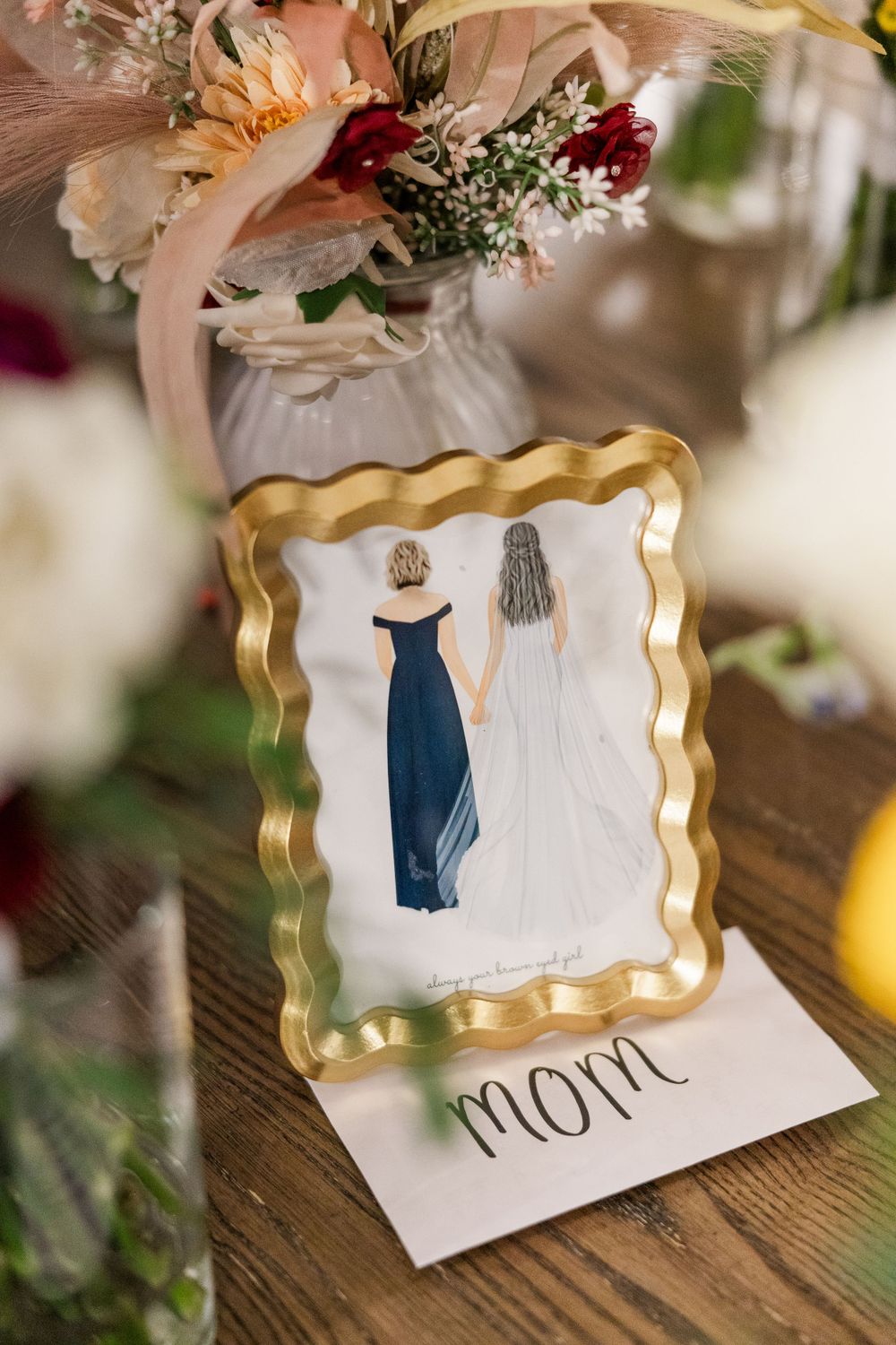 Framed illustration of a bride and mother in blue dress with gold frame detail and the word 'mom' underneath.