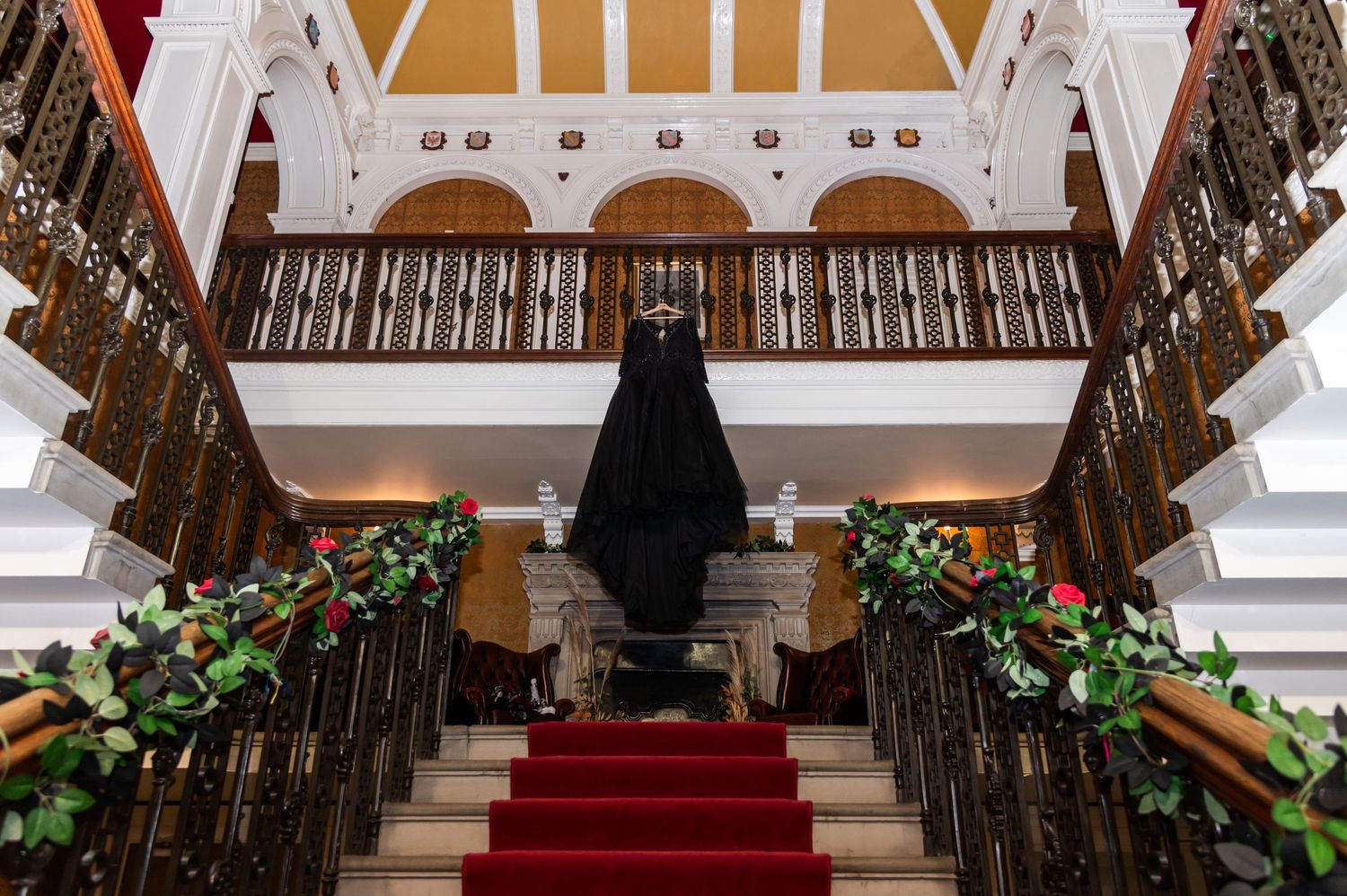 Grand interior venue space with ornate ceiling details and dramatic lighting.