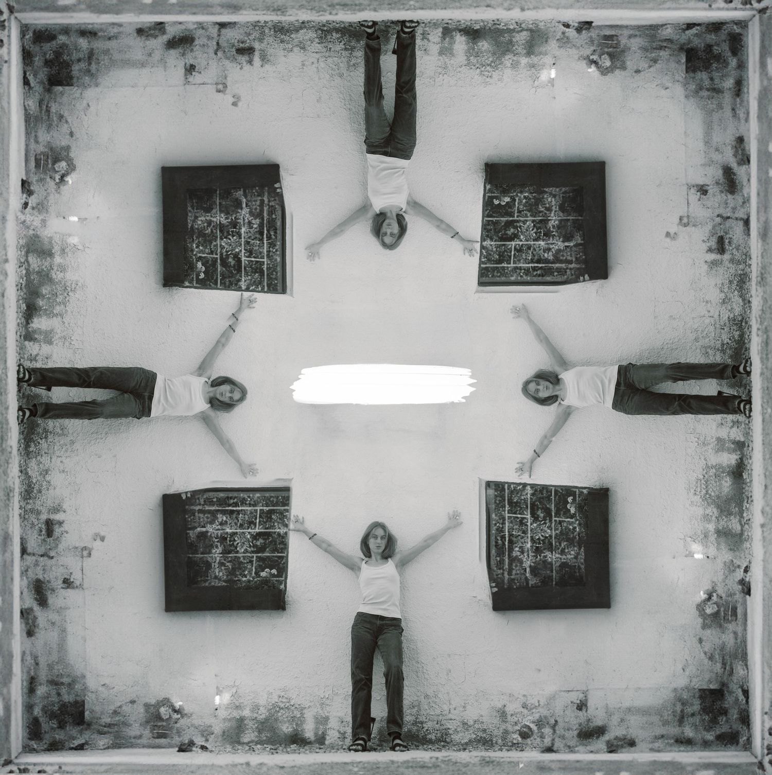 Artistic black and white surreal photo composition with symmetrical square frames and figure arranged in kaleidoscope pattern.