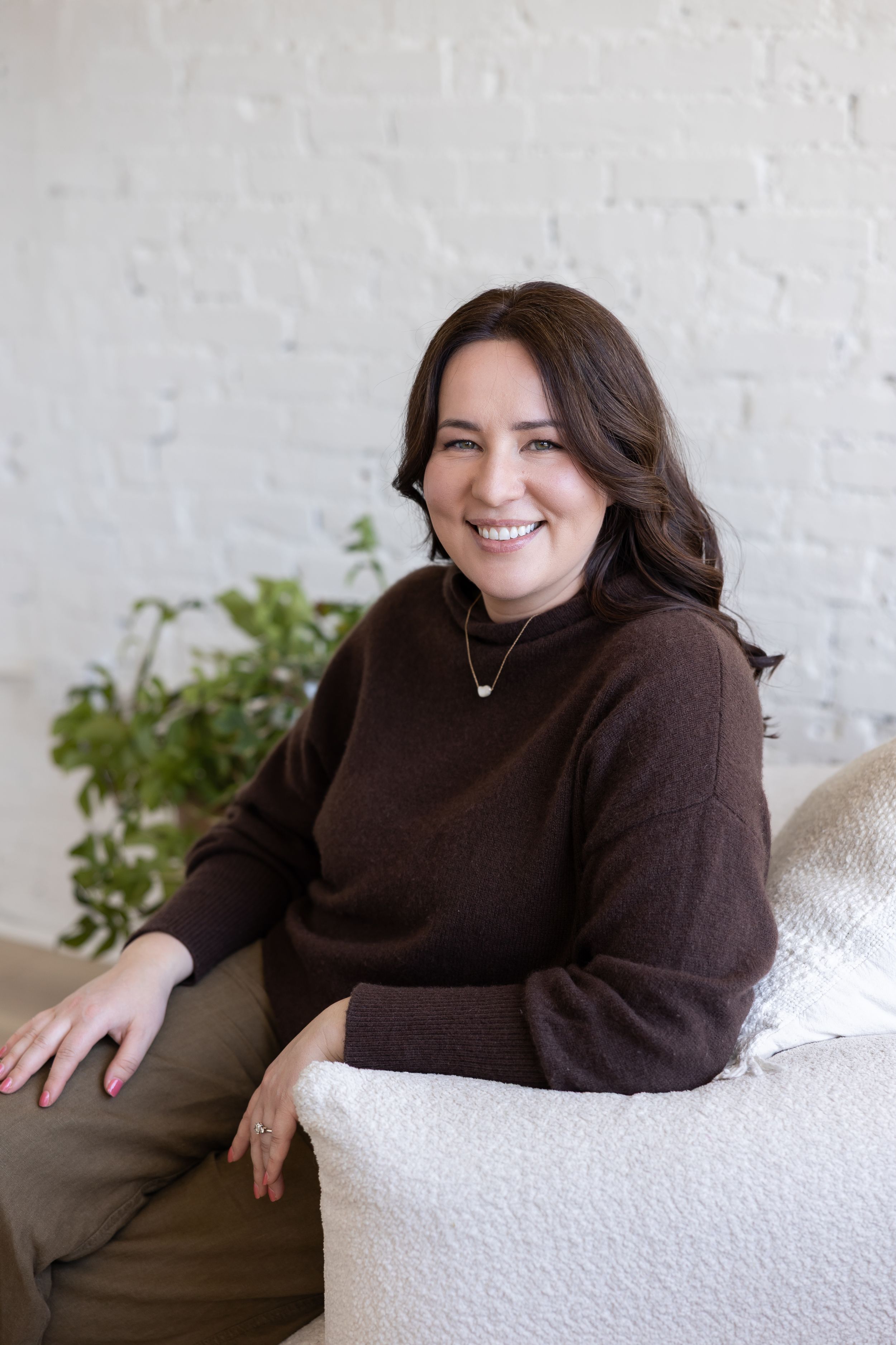 Woman business owner Talks Over Tea Mental Health Therapist in Tacoma, WA personal branding sitting on white couch in studio