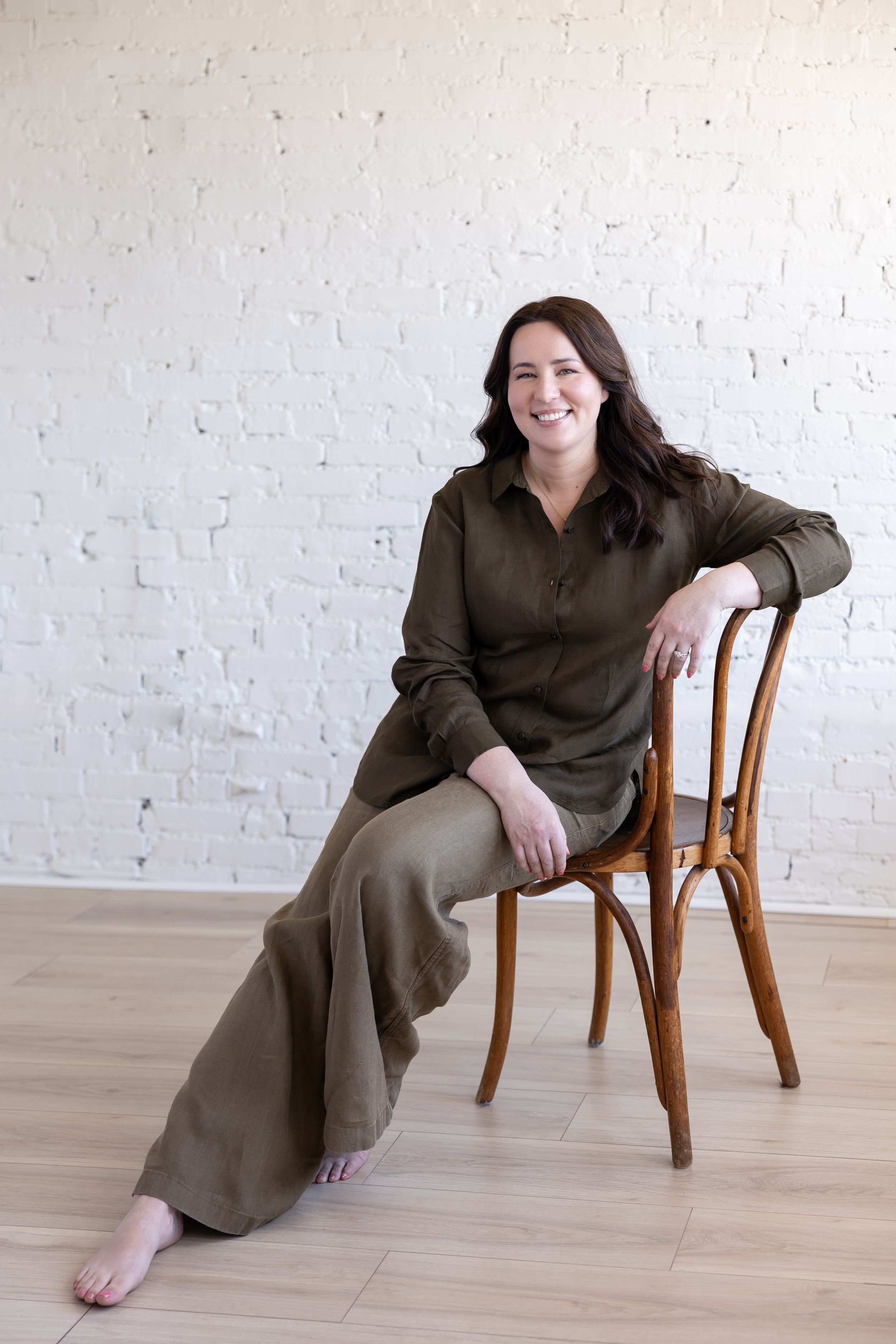 Woman business owner Talks Over Tea Mental Health Therapist in Tacoma, WA personal branding sitting on chair posed in studio
