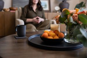 Woman business owner Talks Over Tea Mental Health Therapist in Tacoma, WA personal branding in client session talking with tea in focus