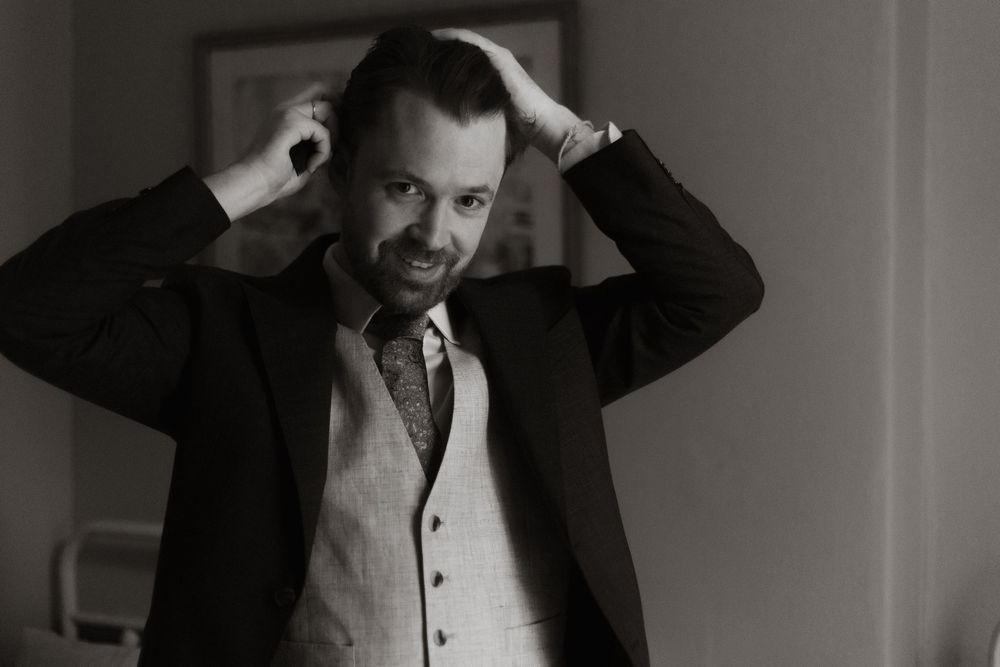 A series of black and white headshots showing different expressive poses and gestures.
