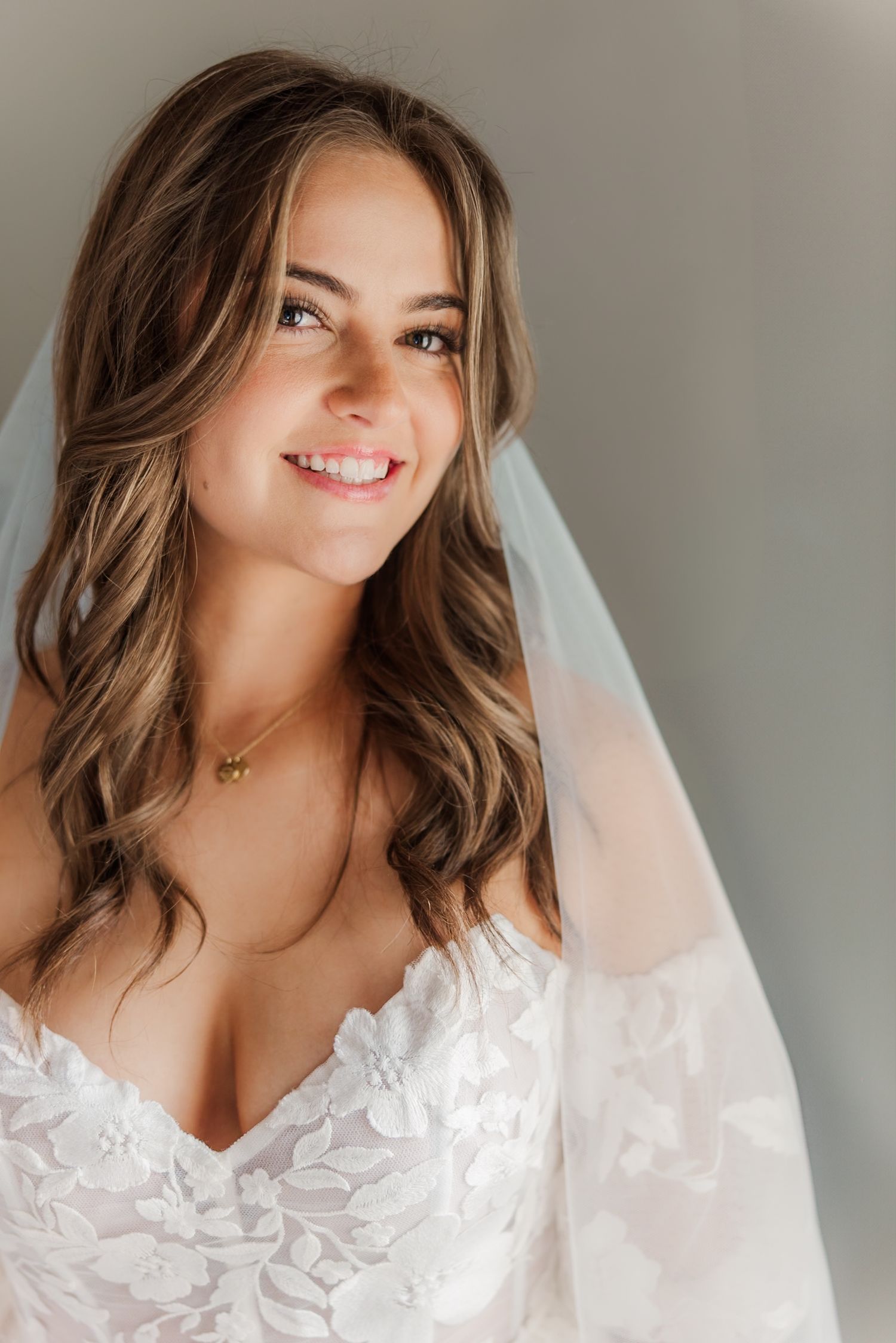 Close-up bridal portraits showcasing delicate lace details and flowing veil.