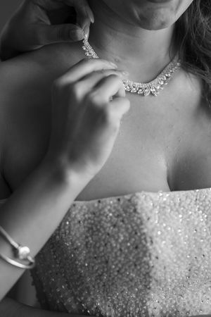 Close-up of crystal necklace and bracelet details on a bride's wedding attire.