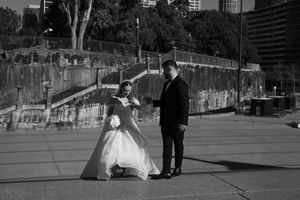 Black and white wedding photography session on Sydney waterfront promenade.
