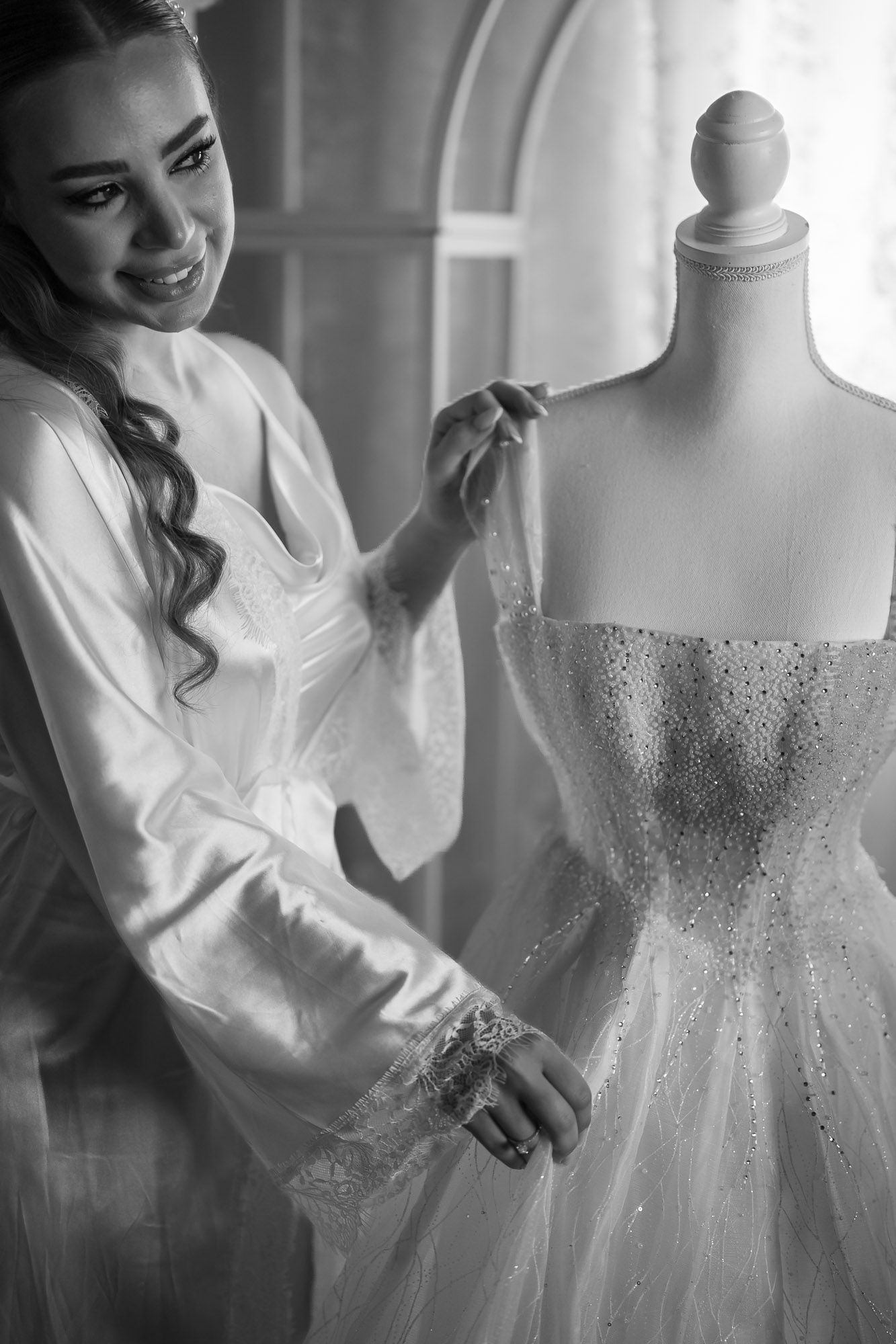 Black and white photos showing wedding dress preparation details.