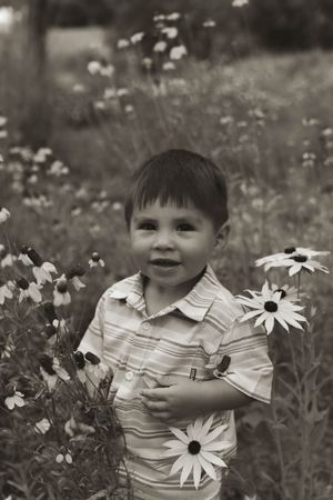 Black and white portrait among blooming white daisies in a summer garden.