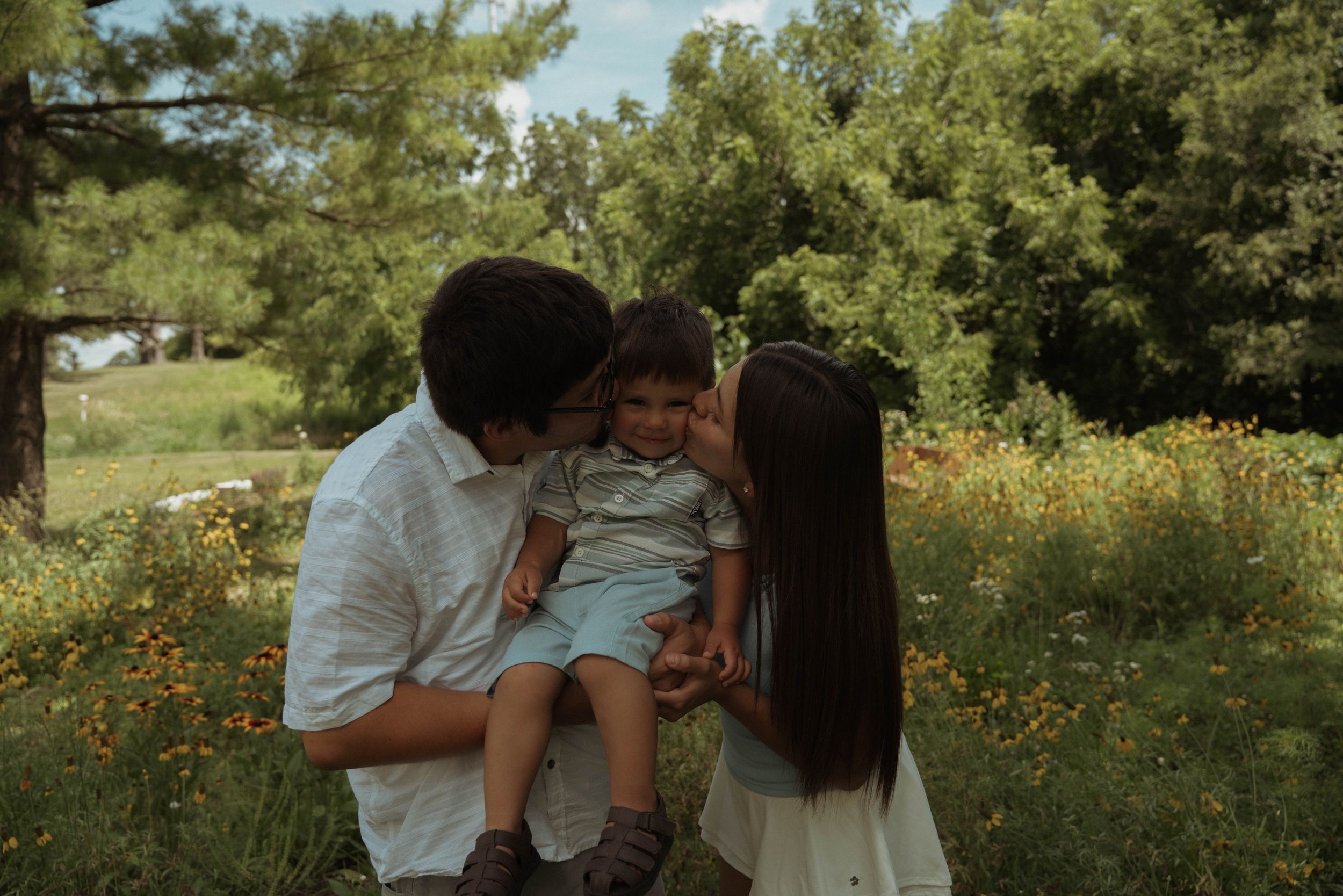 A joyful family gathering in a sunlit meadow with golden flowers.