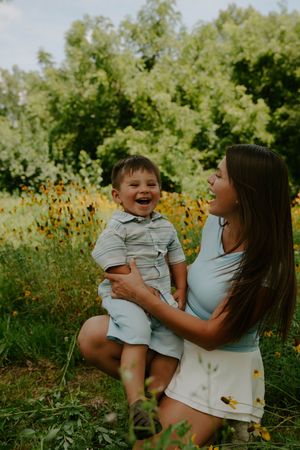 A heartwarming moment shared between family members among yellow wildflowers.
