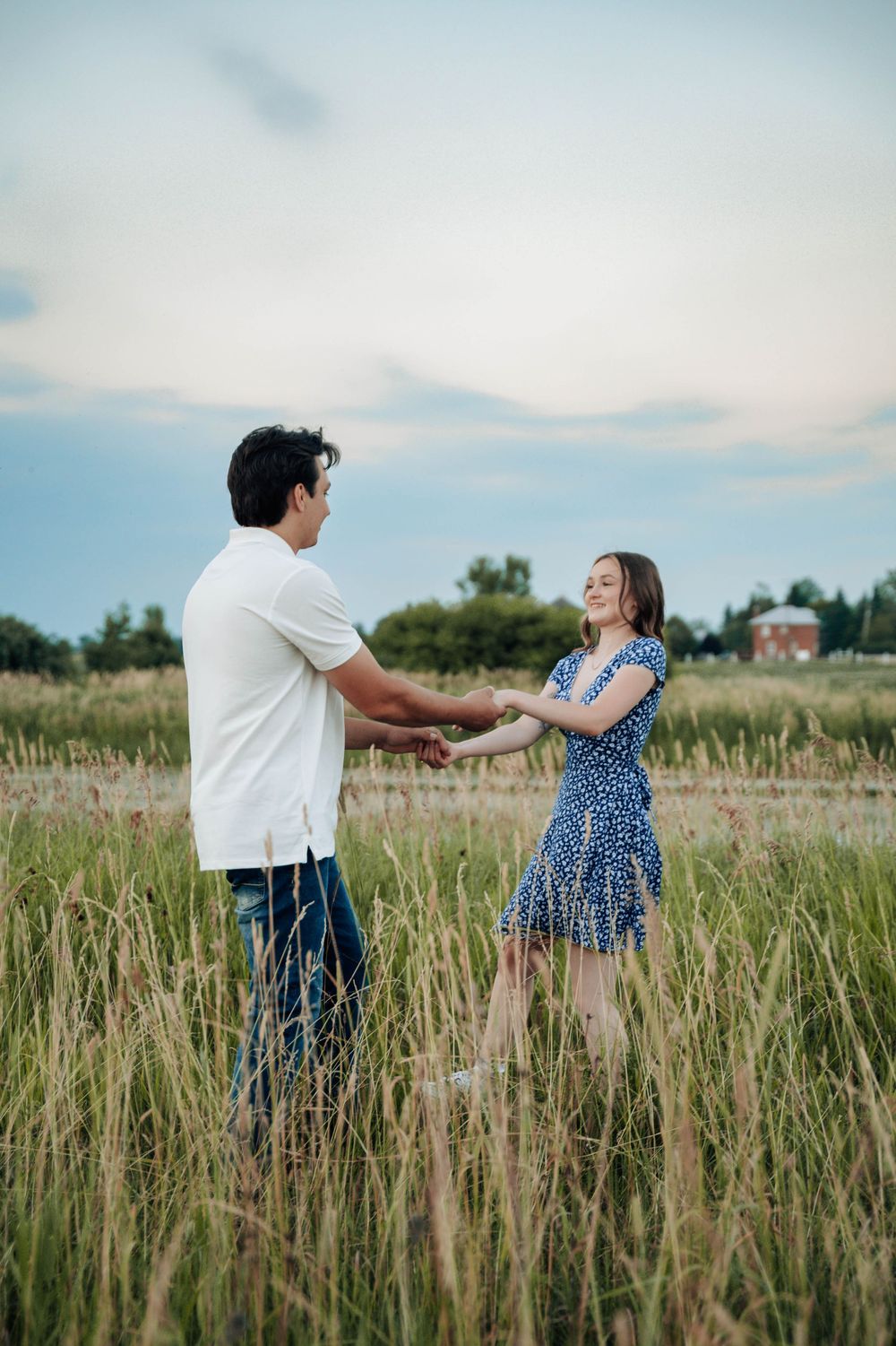 Dancing together in a meadow with wildflowers and tall grass swaying in the summer breeze.
