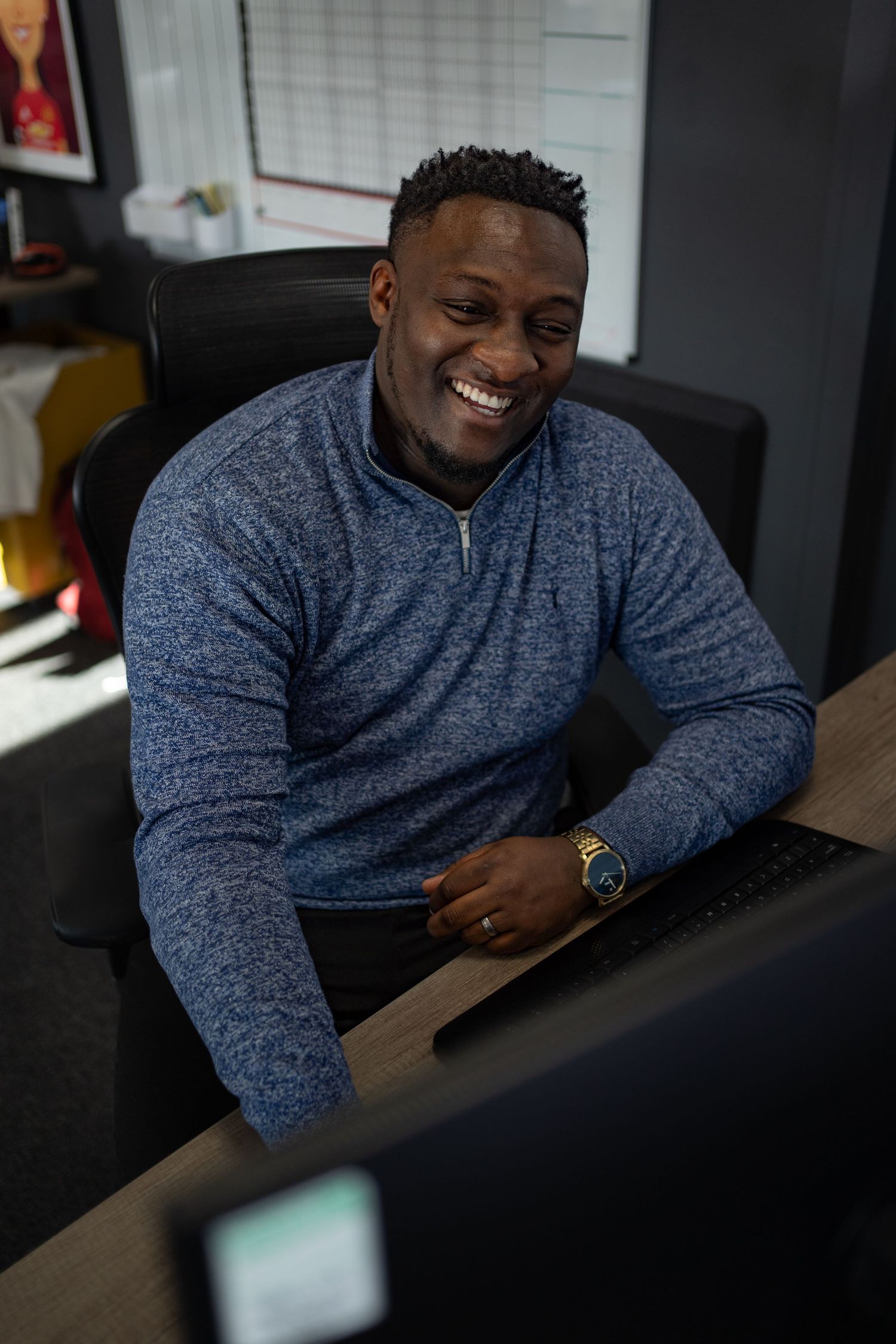 Employee sits smiling during a company photoshoot with a recruitment business in Portsdmouth, Hampshire.