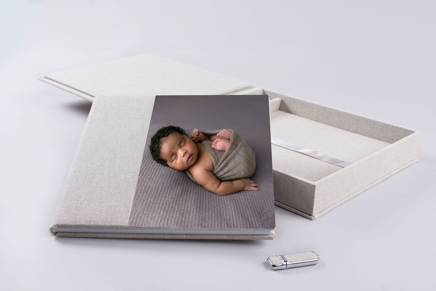 Orlando FL Newborn Photography Album baby posed in a swaddle blanket