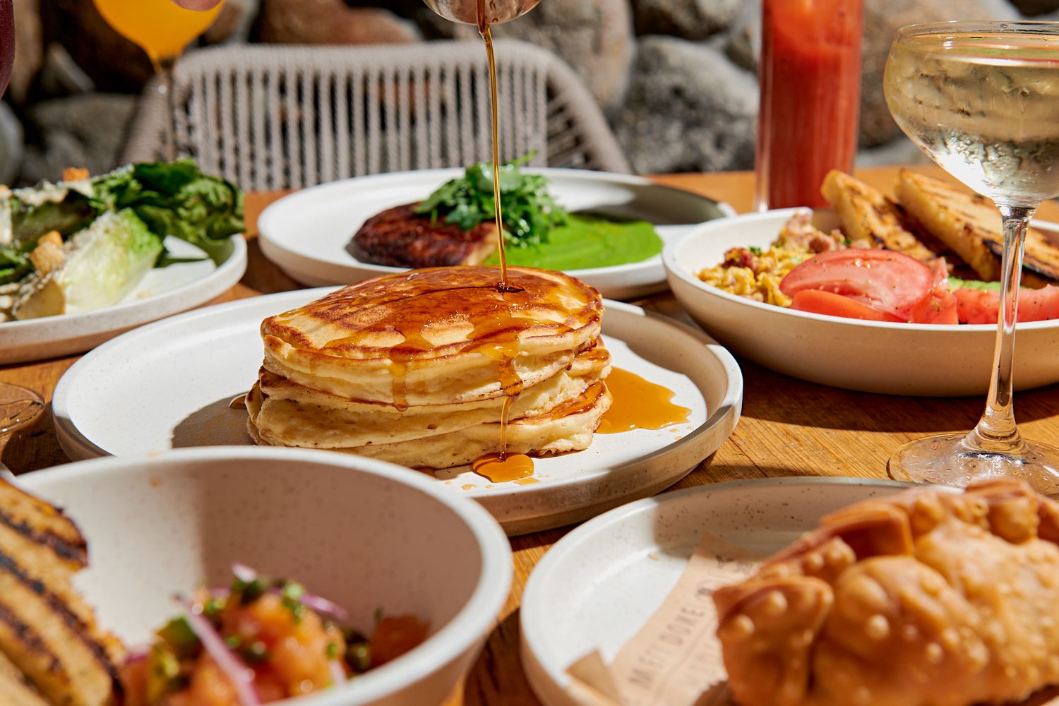 Breakfast table with pancakes being drizzled with maple syrup. Gustavo Lopez Photography. Nashville Food Photographer.