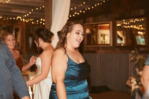 Guests enjoying a festive moment on the dance floor at a barn wedding reception.