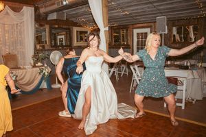Group dance moments captured at a wedding reception showing people in formal attire on a wooden dance floor.